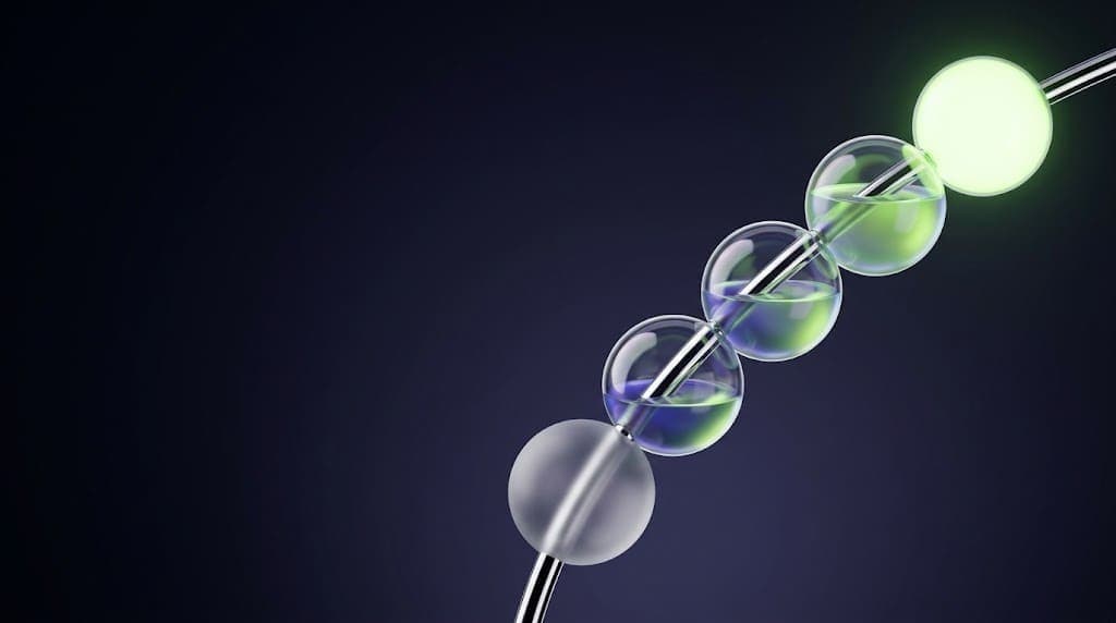 Five glass spheres on a curved chrome rod, filling from empty to glowing green, symbolizing project stages from discovery to maintenance